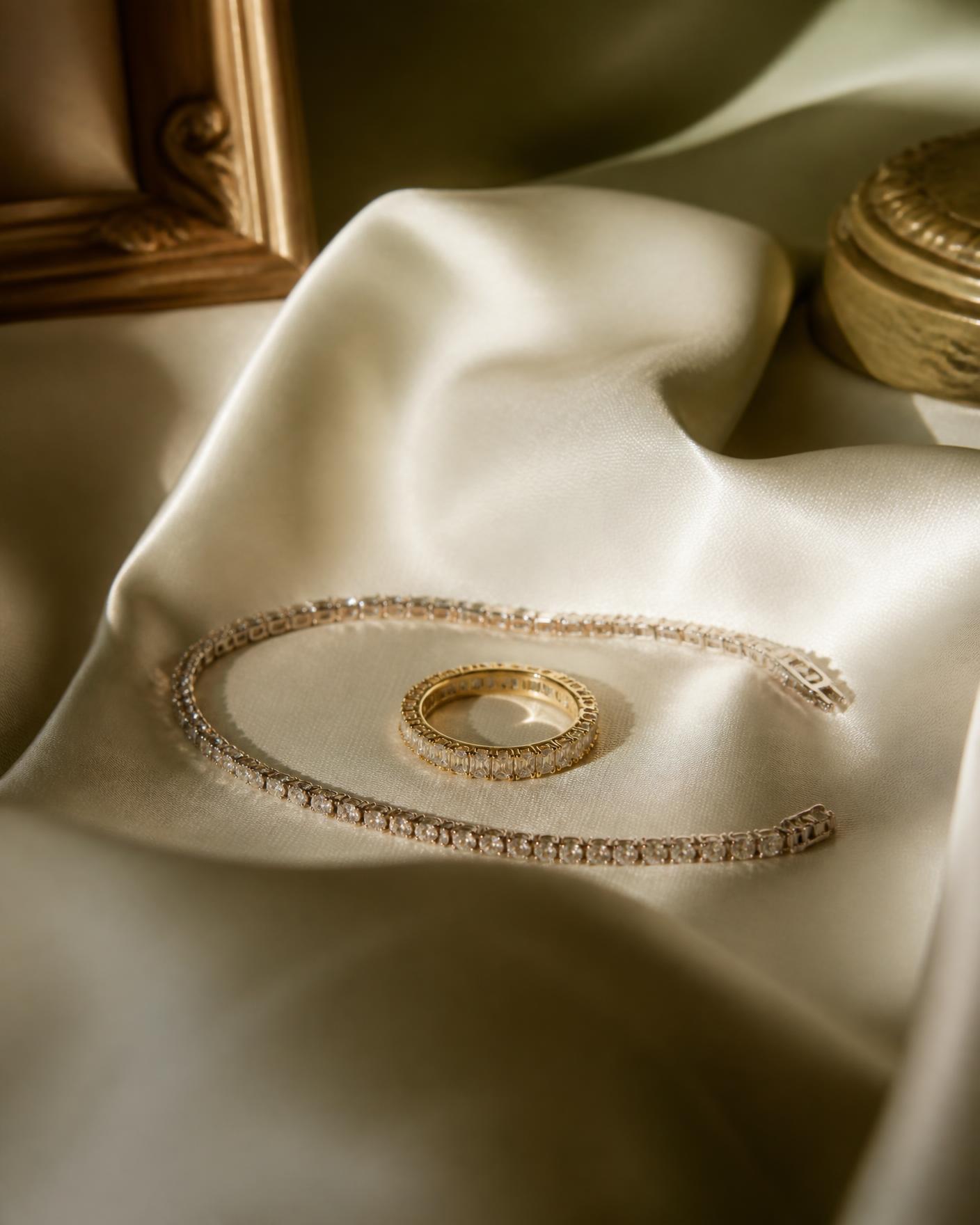 Diamond tennis bracelet and gold eternity band on ivory silk